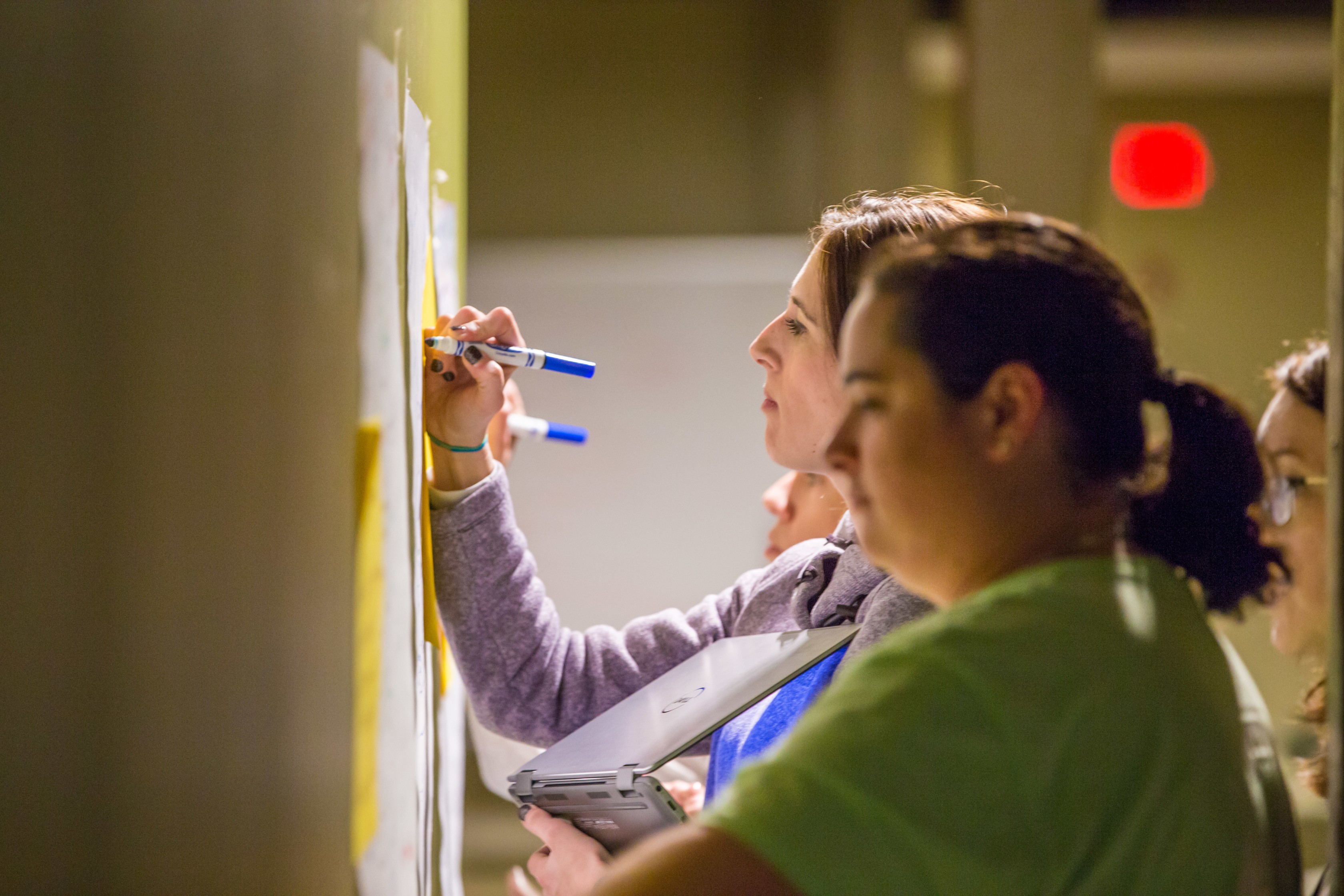 grad students workingon whiteboard together