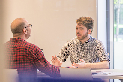 A student speaking with a professor