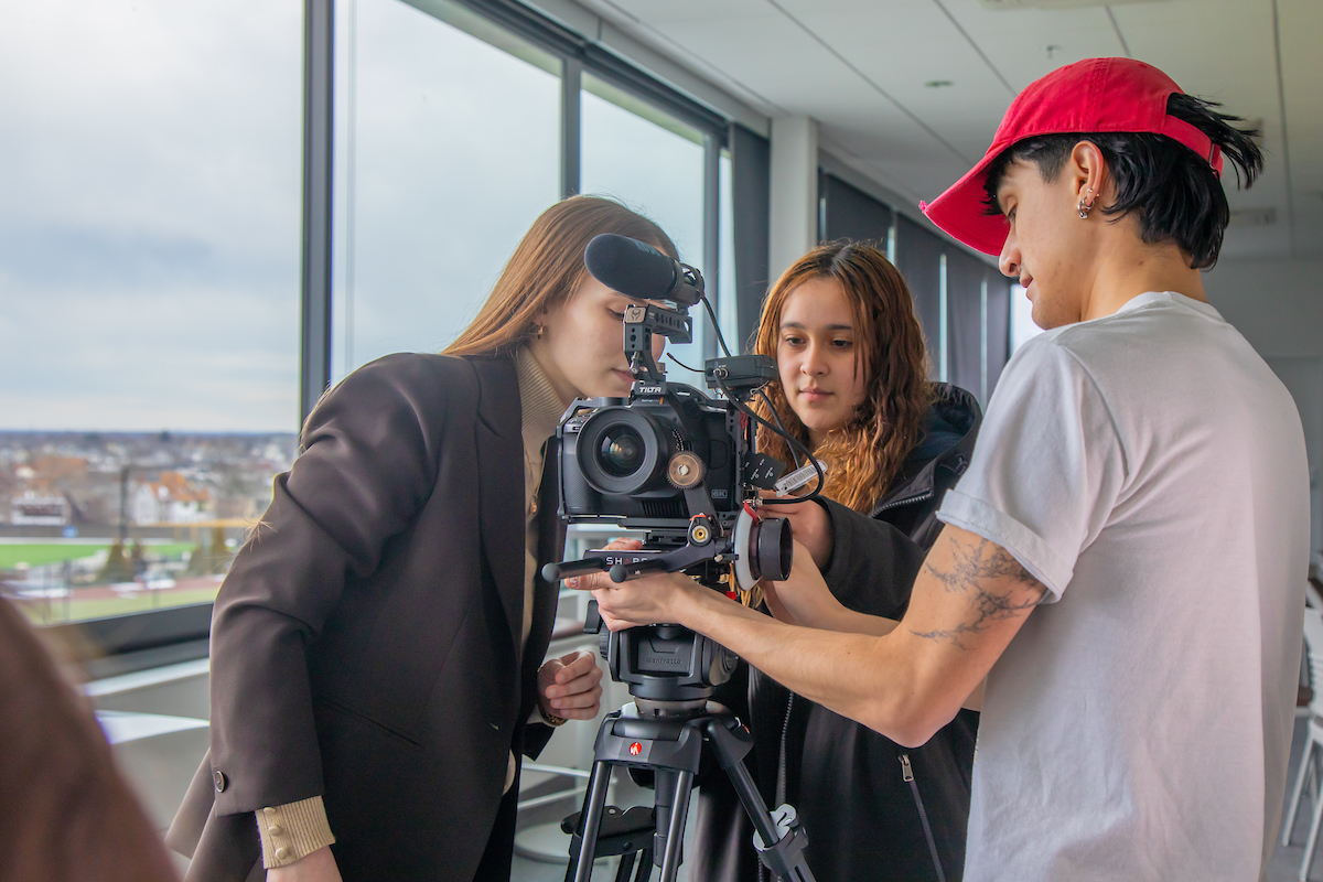 group of young college students using camera