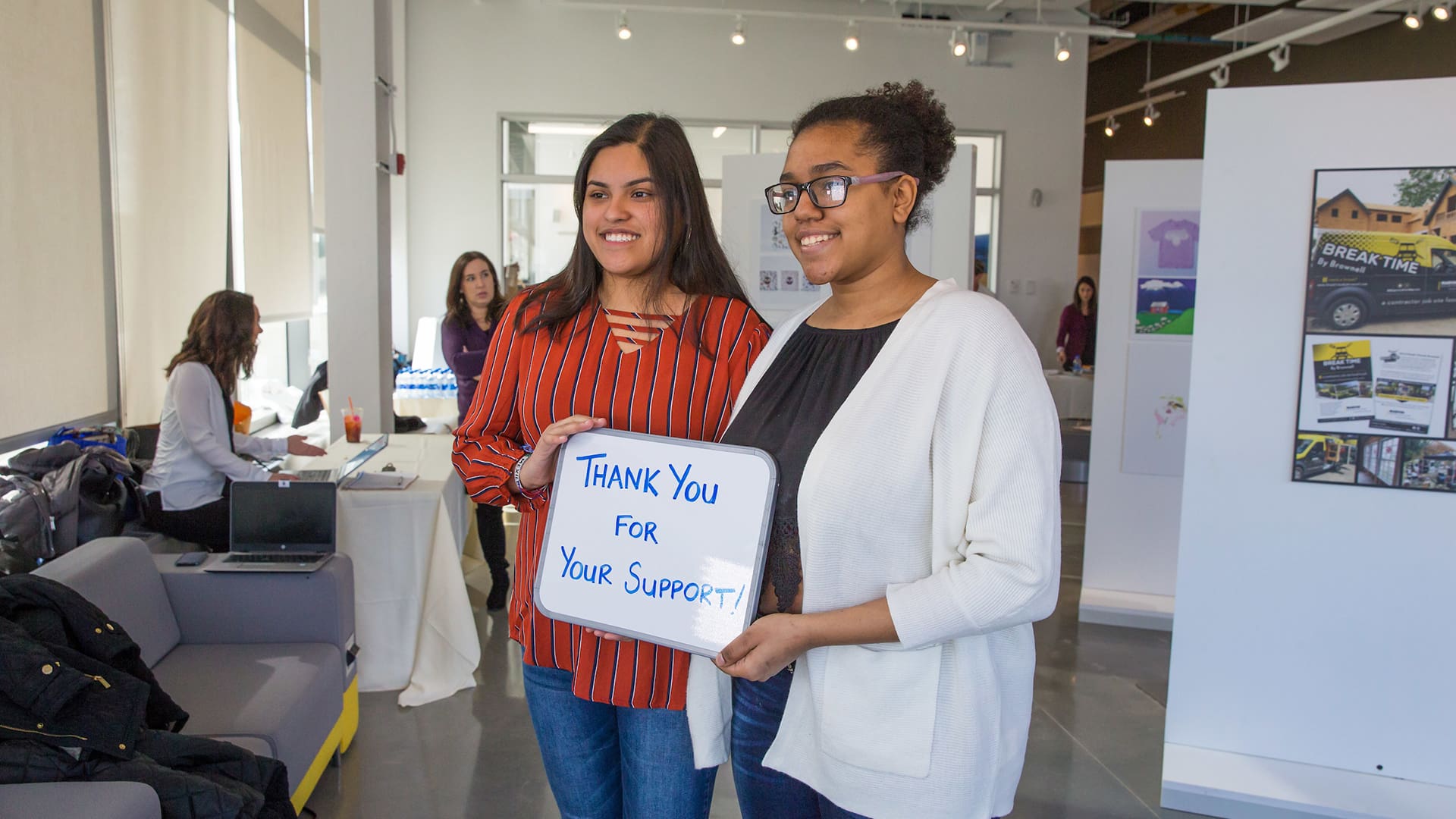 Students show off their thank you support sign.