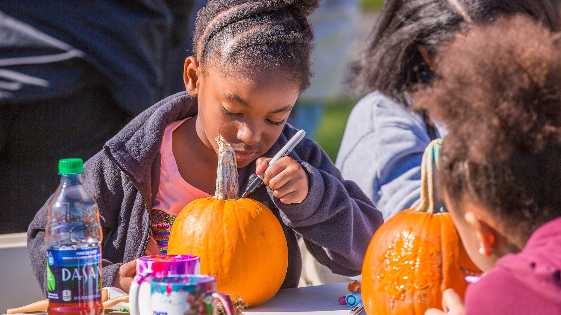 Painting pumpkins at Family Weekend