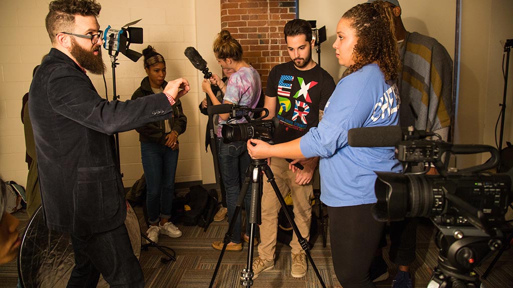 Professor Evan Vallari works with a student camera crew 