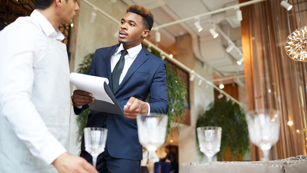 Event manager speaking to employee