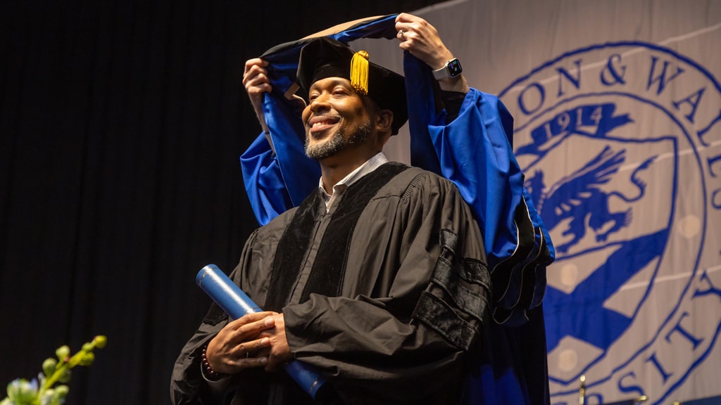 Conferring the master’s academic hood.