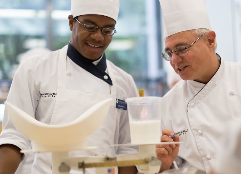 baking student learning to measure ingredients