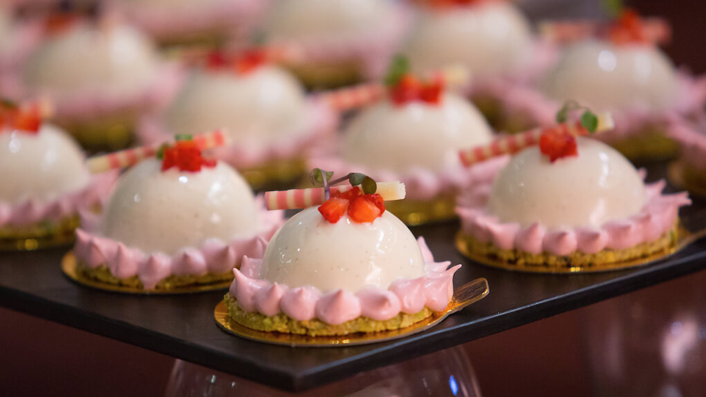 Pink petits fours in a row