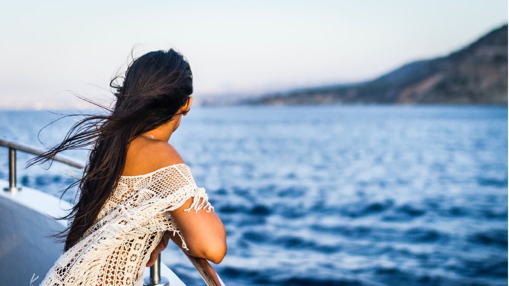 a girl watching the sunset on a cruise