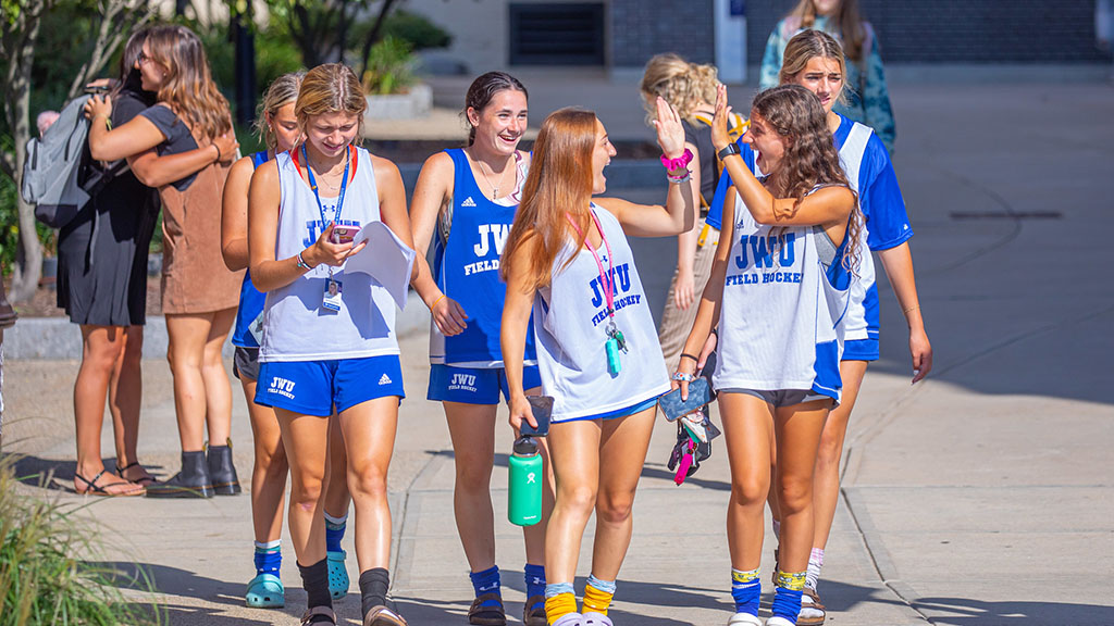 JWU field hockey athletes walking on campus