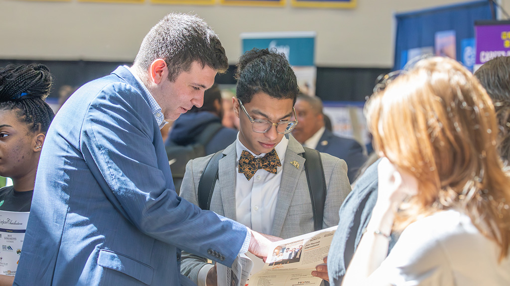 Two men reading a flyer