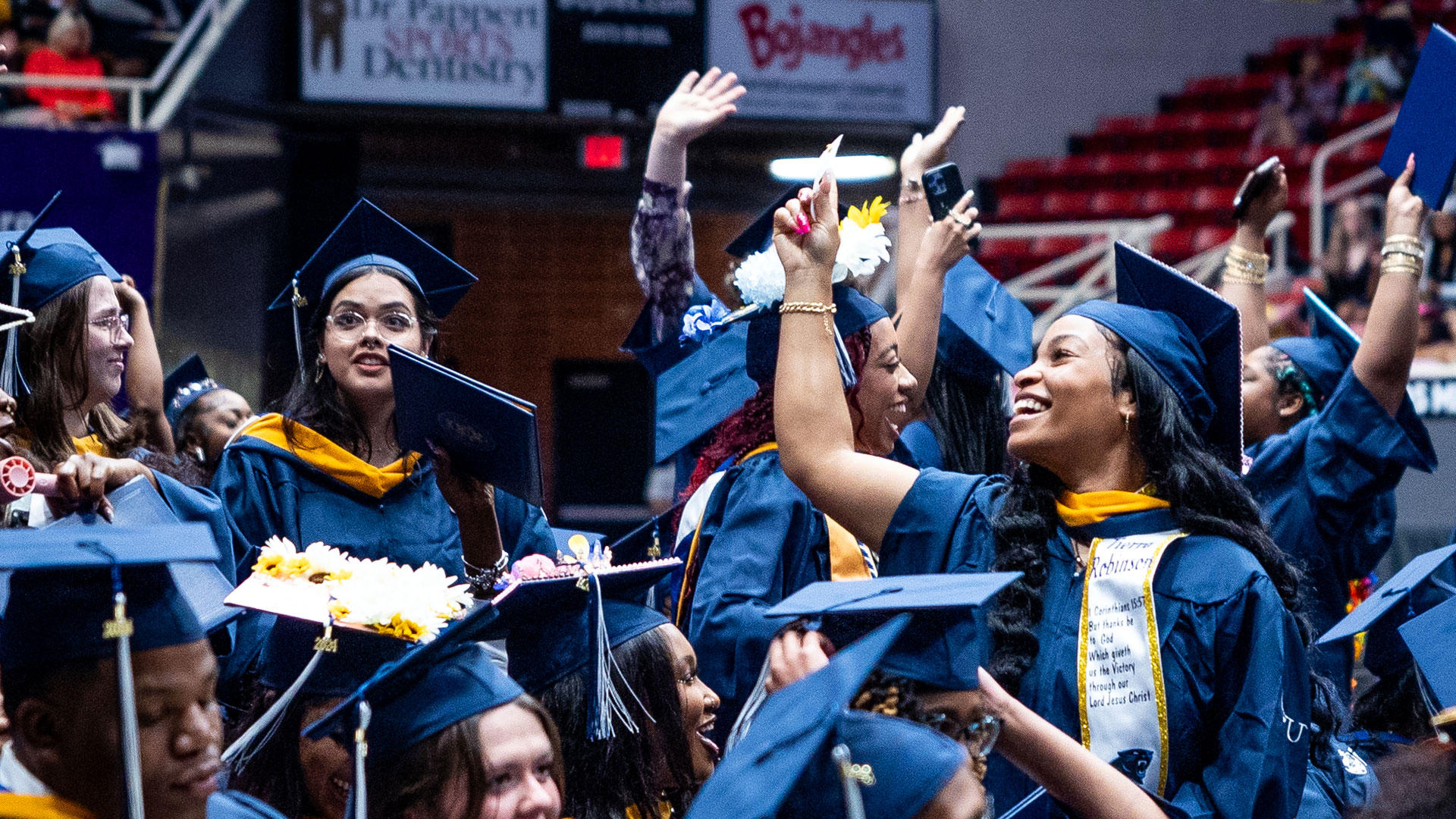 New grads cheering at JWU Charlotte Commencement.