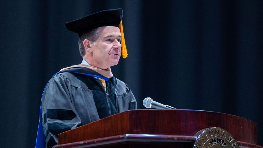 Michael Smith '24 Hon. at the Charlotte Commencement podium.