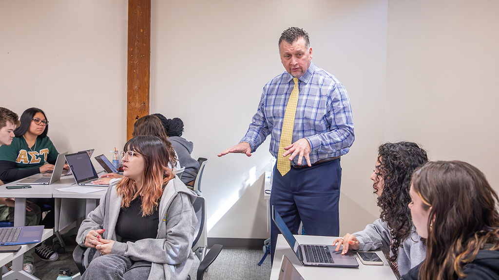 Professor Paul Sylvestre talking to students in the classroom