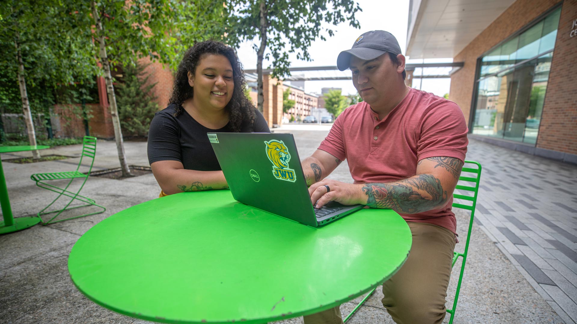 photo of a man and woman sitting together looking at a laptop