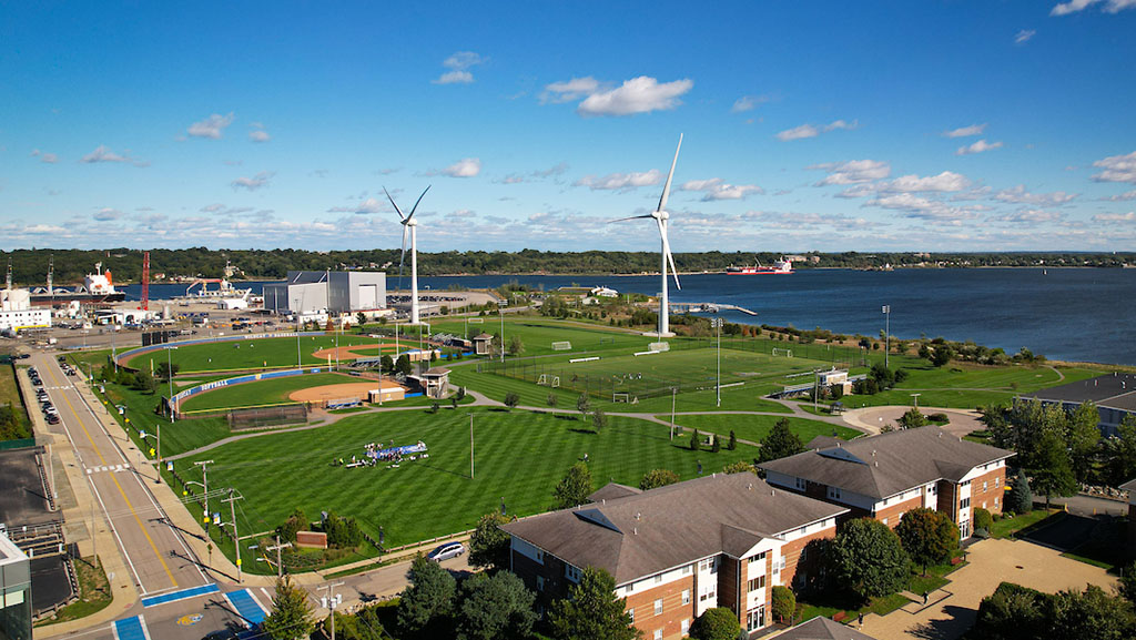 Aerial view of the athletics fields and two wind turbines.