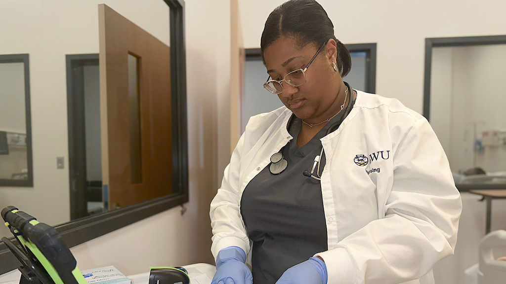 JWU nursing student working in the fully functional simulation center designed to mimic a wide range of medical scenarios across the patient lifespan.