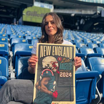 a photo of Karyn Jimenez-Elliott holding up the NE Patriots poster she designed