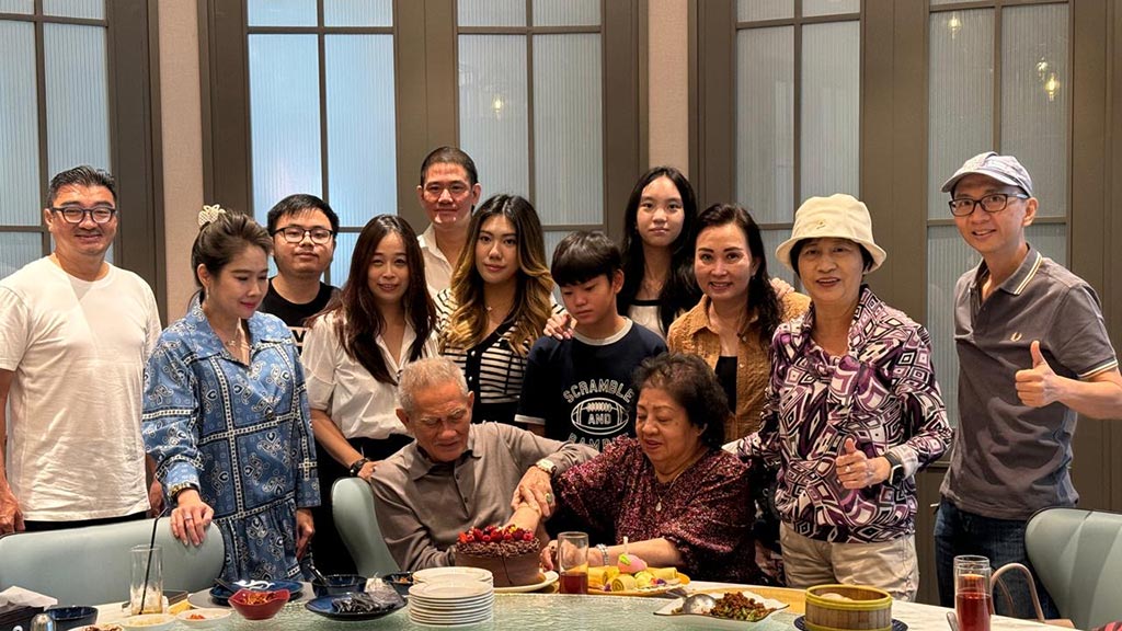 a photo of a family gathering together at a table