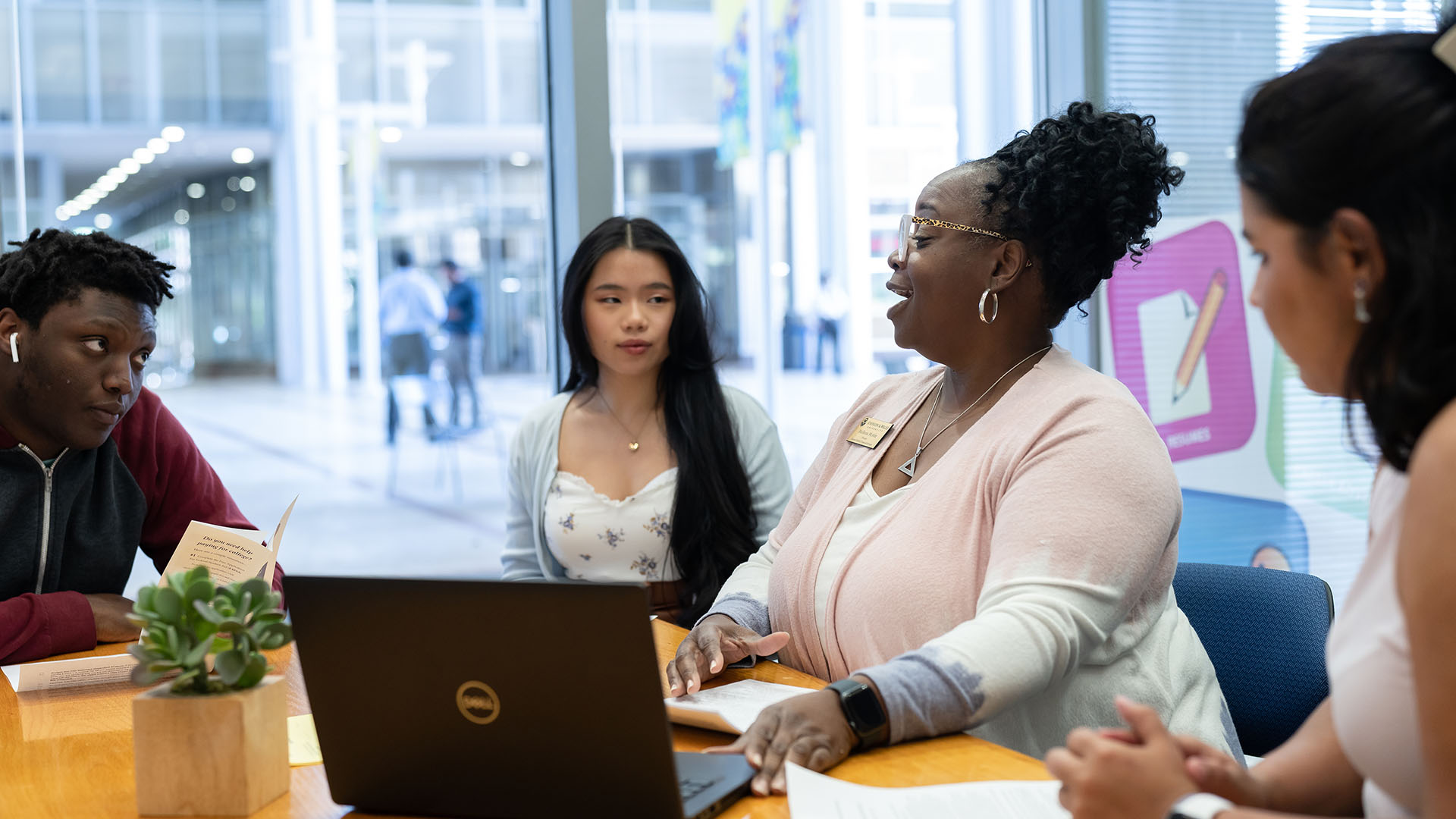 Students sitting at a table with academic services