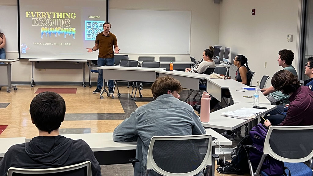 a student pitches an idea to other students at The Launch Pad Club's 2024 Fishbowl event