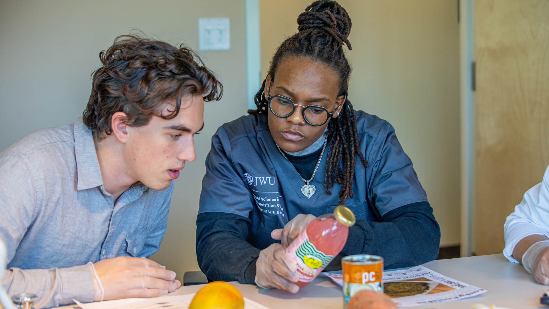 clinical nutrition students examine foods and beverages in class