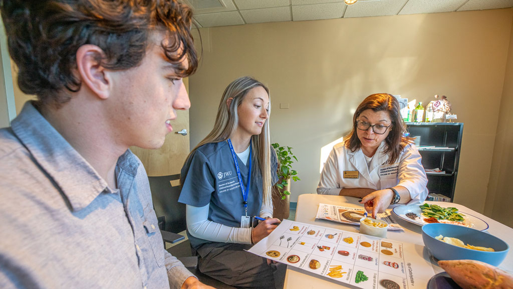 candid of some students and a professor examining nutrition items