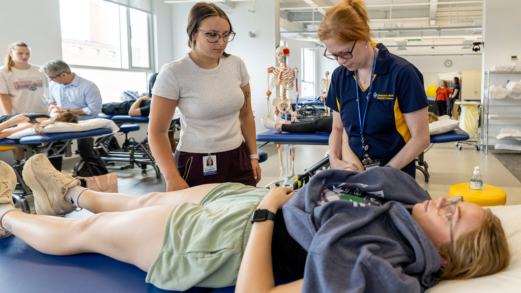 Assistant Professor Emily Berthelette demonstrating techniques to students