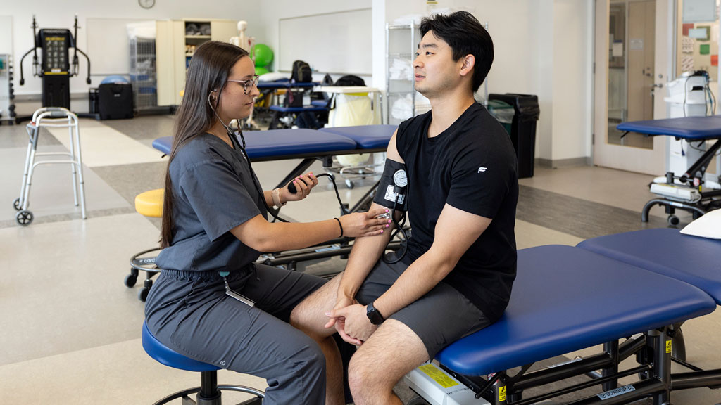 DPT student Abigail Griffin '27 checking vitals of student Aiden Kong '27
