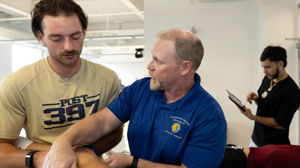 Associate Director and Associate Professor Justin Laferrier demonstrating treatment techniques