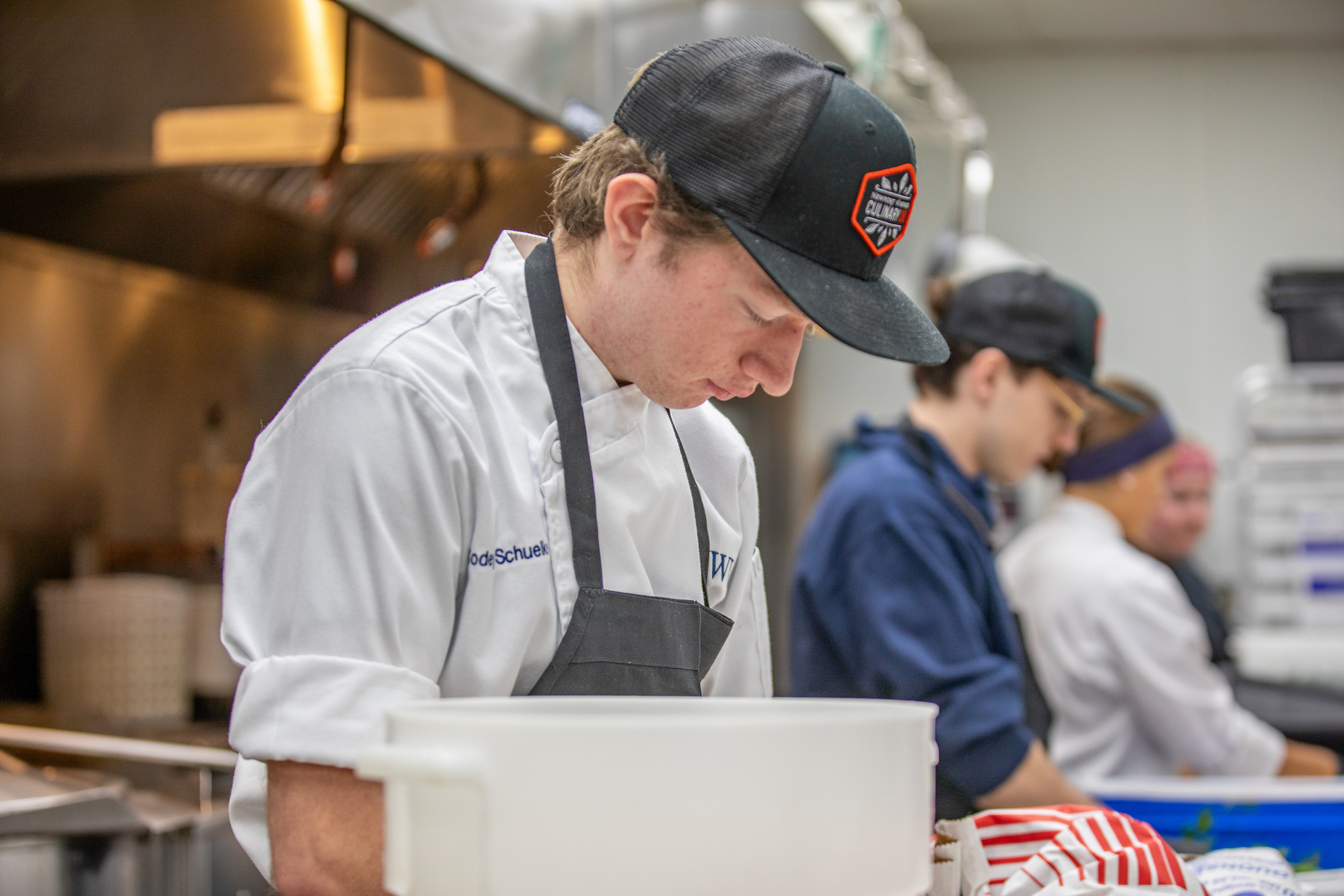 Codey Schuelke ’28 helping prepare food for an event.