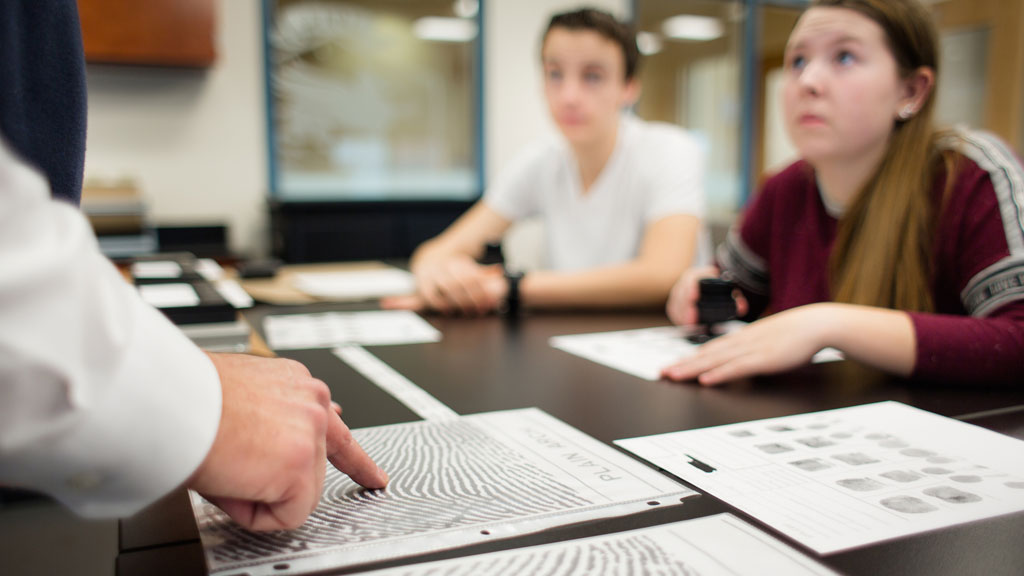 Criminal Justice students learning about fingerprint process.