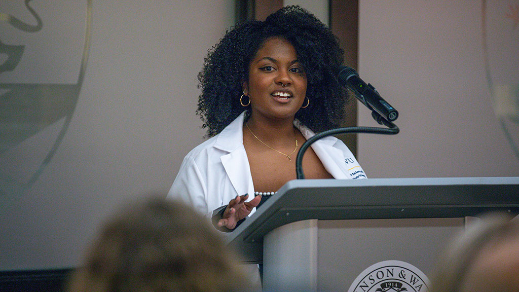 photo of Maite-Abigail Denis '25 M.S. speaking at the MSCND pinning ceremony