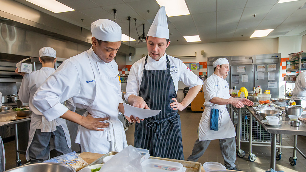 Branden Lewis in the kitchen with students