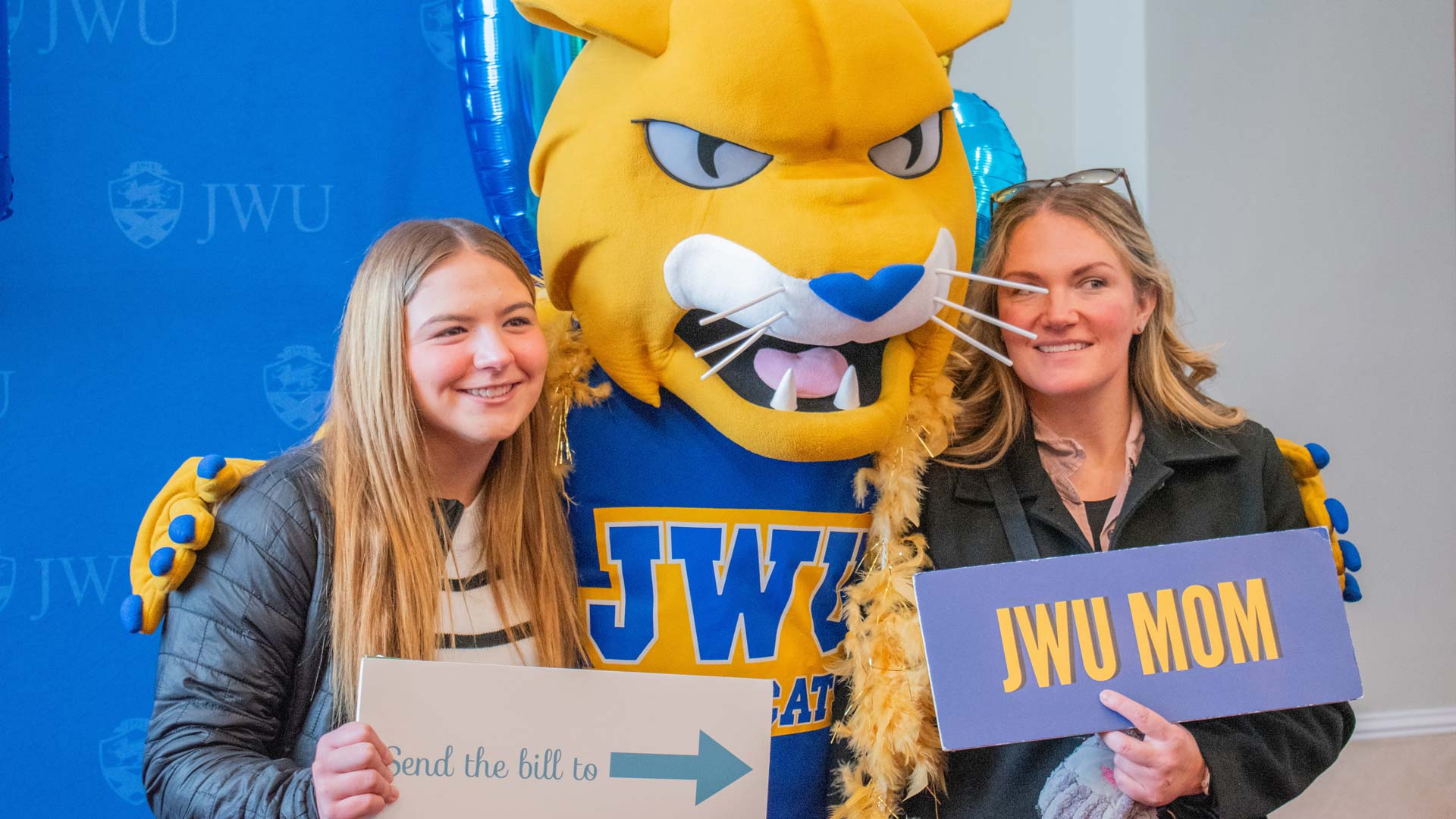 A mom and daughter posing with Wildcat Willie