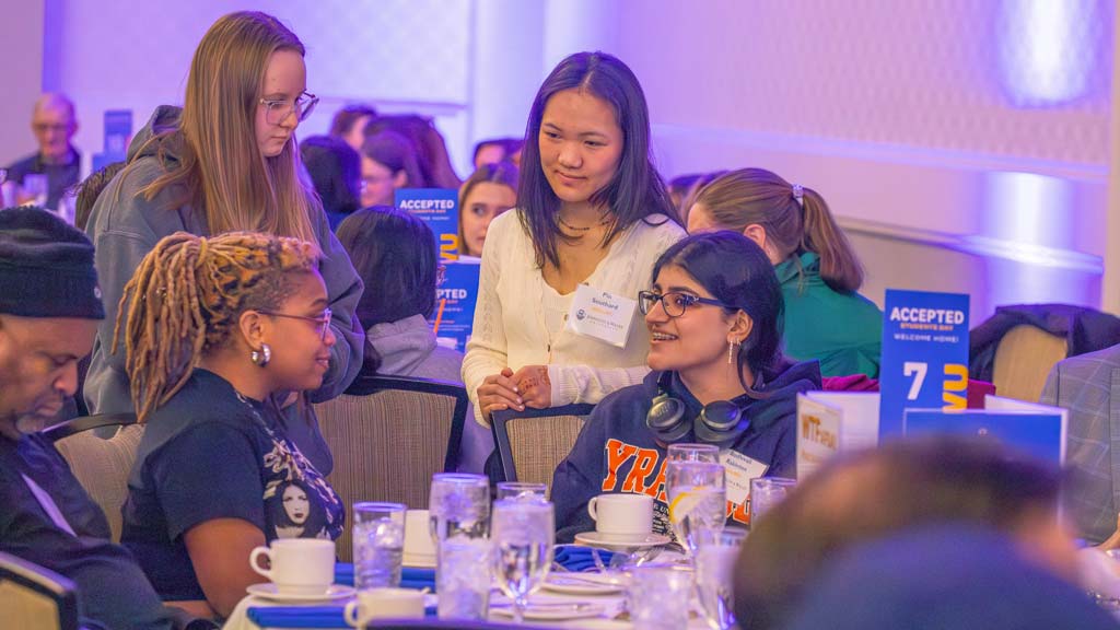 Students talking to one another at a table