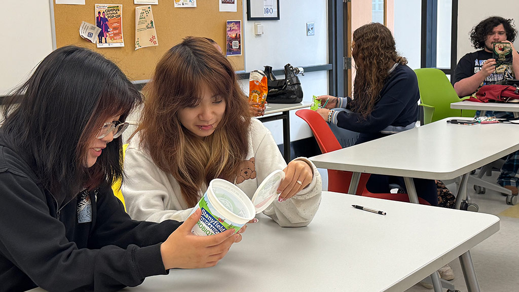 two JWU Charlotte students read food labels in a classroom