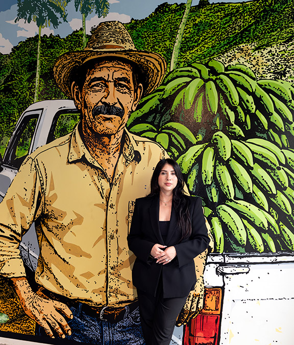 Andrea Cabrera '16, '18 MBA stands before a mural