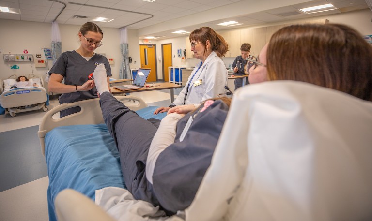 JWU nursing students learn in the simulation lab. 