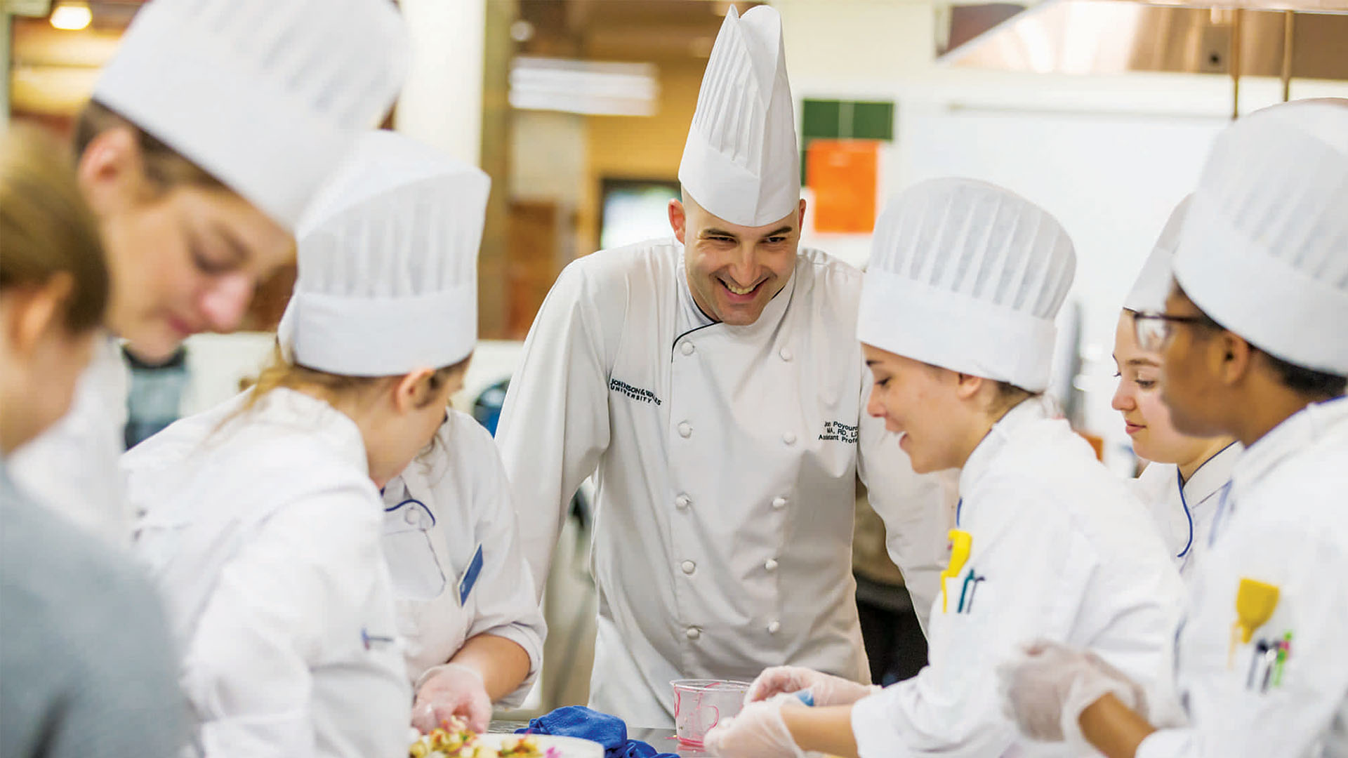 Professor Poyourow, along with culinary and design students, tailors a special meal for the men’s tennis team.